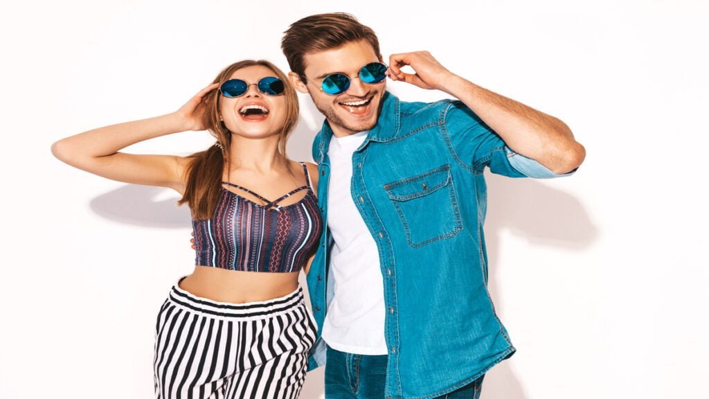 portrait of smiling beautiful girl and her handsome boyfriend laughing happy cheerful couple in sunglasses